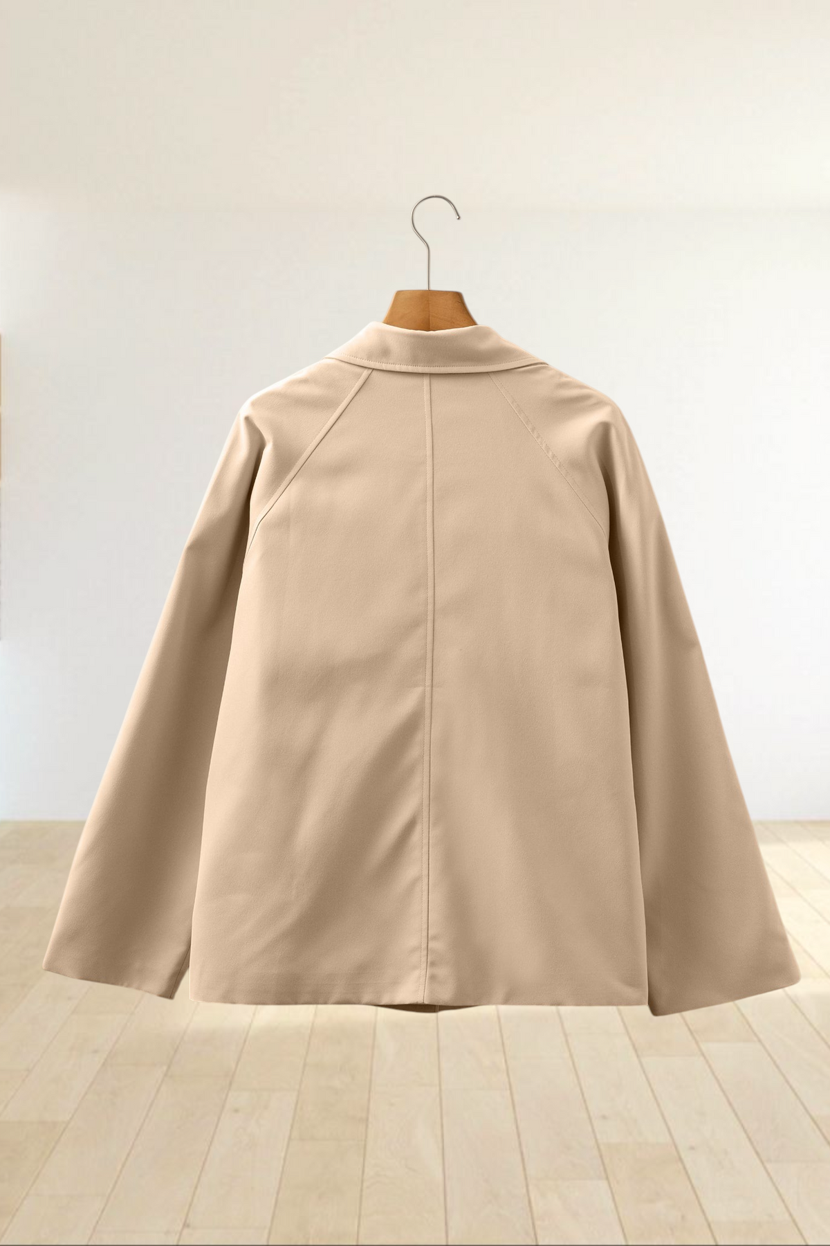 Baya Wear parchment beige cropped trench jacket seen from the back, featuring a structured collar and raglan sleeves.