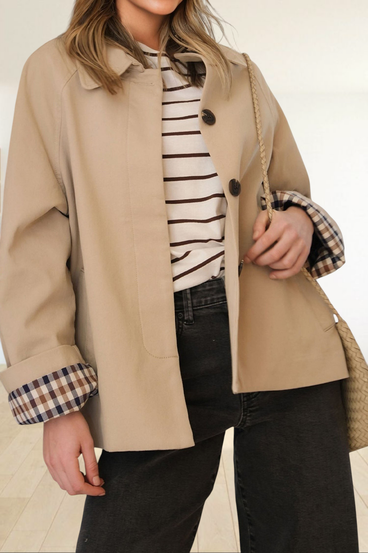 Baya Wear parchment beige cropped trench jacket with button front and plaid sleeve lining worn with striped top
