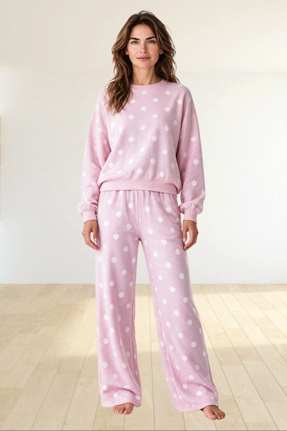 Baya Wear pink polka dot lounge set with a crewneck balloon sleeve sweatshirt and wide leg pants on a woman