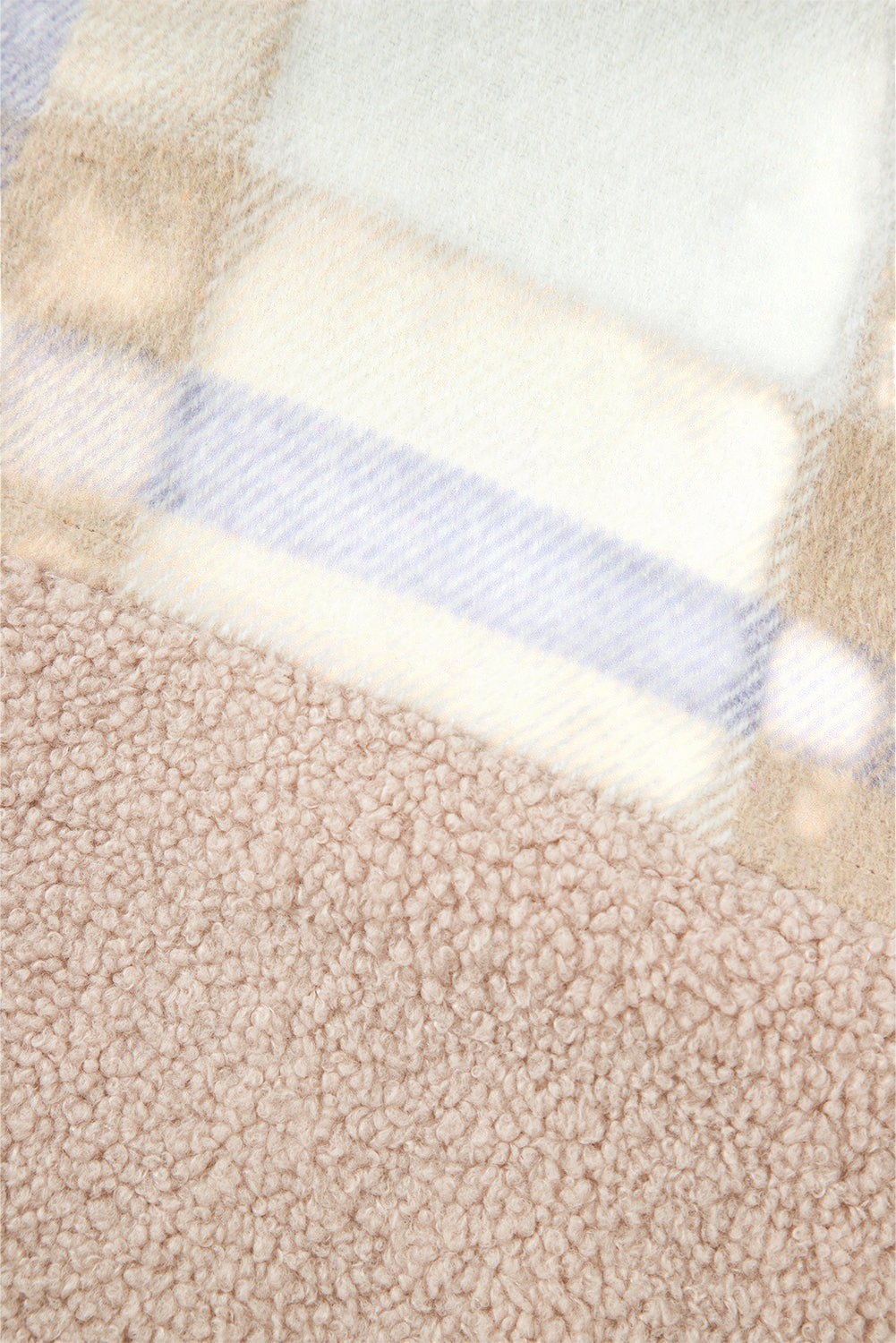 Baya Wear longline shacket featuring a close-up of plush beige sherpa fabric contrasted with soft plaid patchwork.