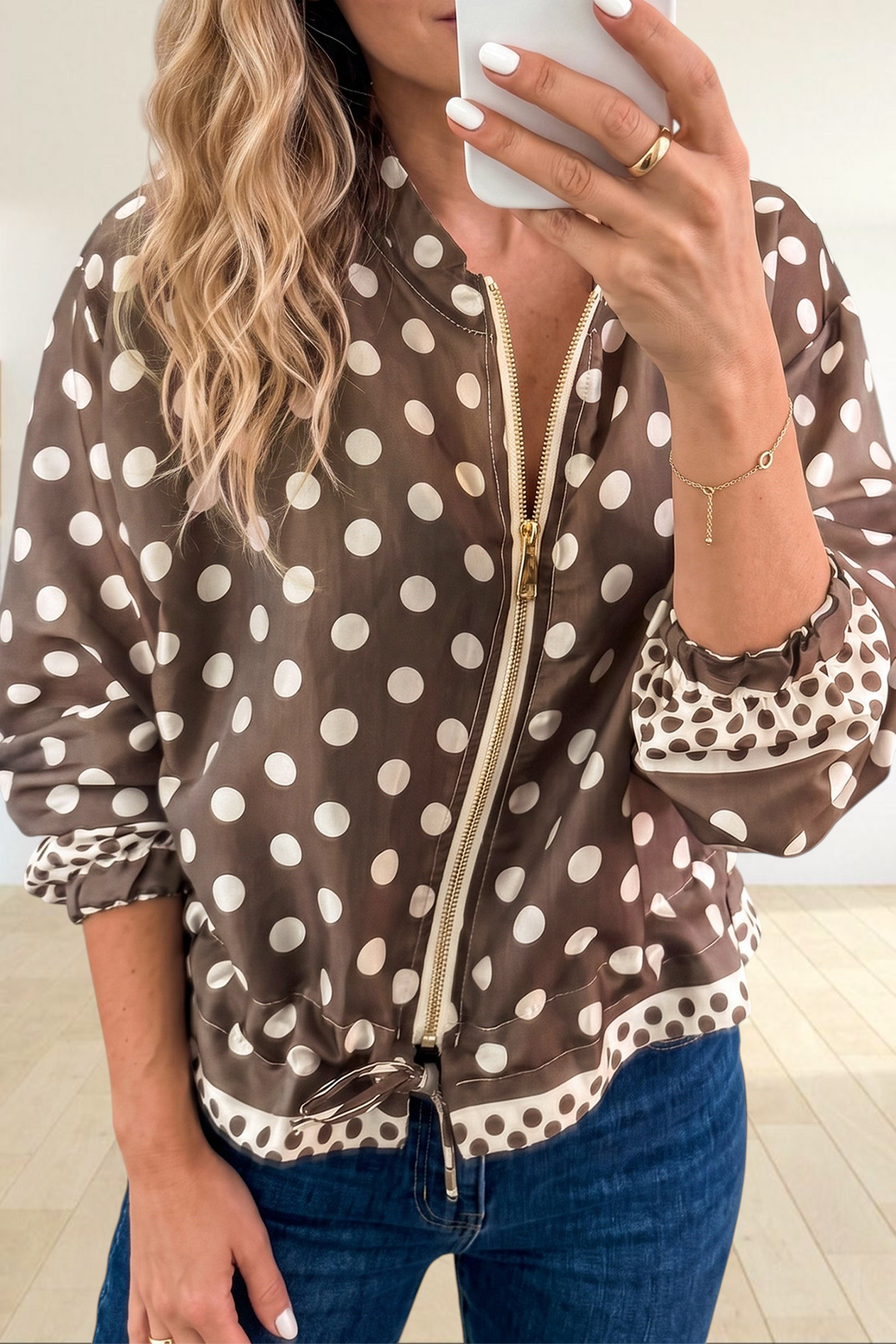 Baya Wear brown polka dot zip-up bomber jacket with gold hardware, tie-waist, and contrast cuff detail.