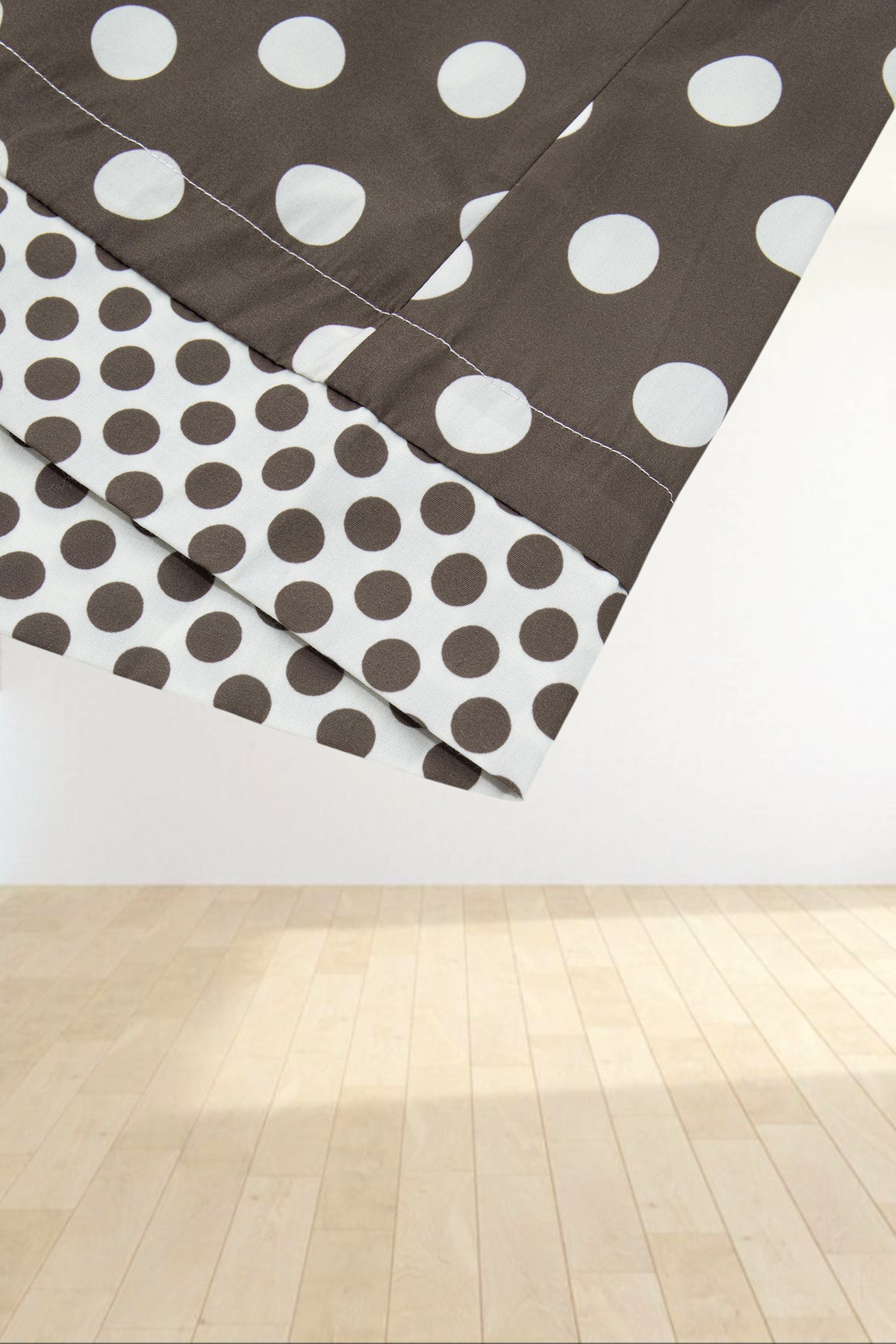 Baya Wear brown polka dot bomber jacket cuff detail with contrasting pattern on a light grey background