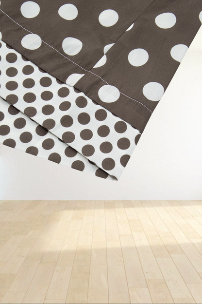 Baya Wear brown polka dot bomber jacket cuff detail with contrasting pattern on a light grey background