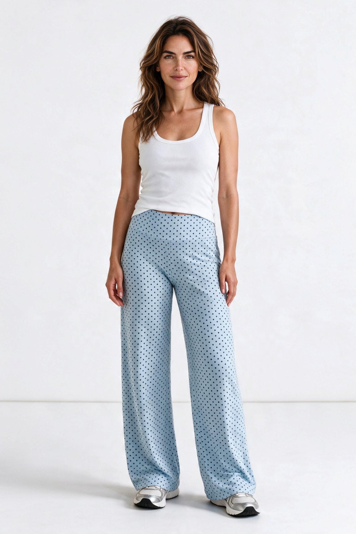 Baya Wear high-waisted wide leg yoga pants in light blue with navy polka dots, worn with a white tank top