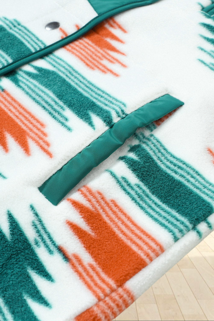 Baya Wear fleece jacket featuring a cream base with geometric orange and forest green patterns and green trim detail.
