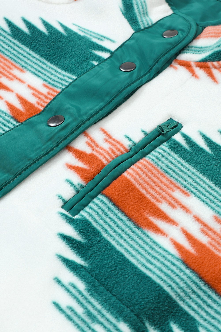 Baya Wear printed fleece jacket with geometric pattern in orange and green, featuring snap buttons and zip pocket.