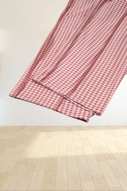 Baya Wear red and white gingham wide leg lounge pants featuring contrast stitching detail on a grey background