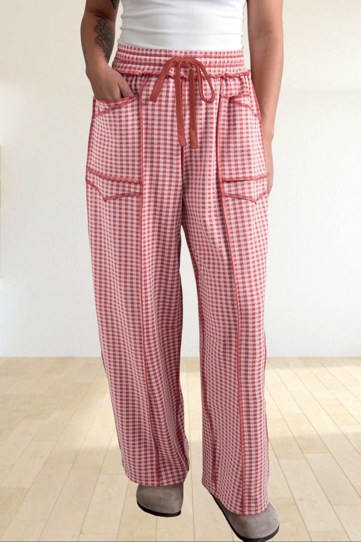 Baya Wear red and white gingham wide leg lounge pants with contrast stitching, drawstring waist, and front pockets.
