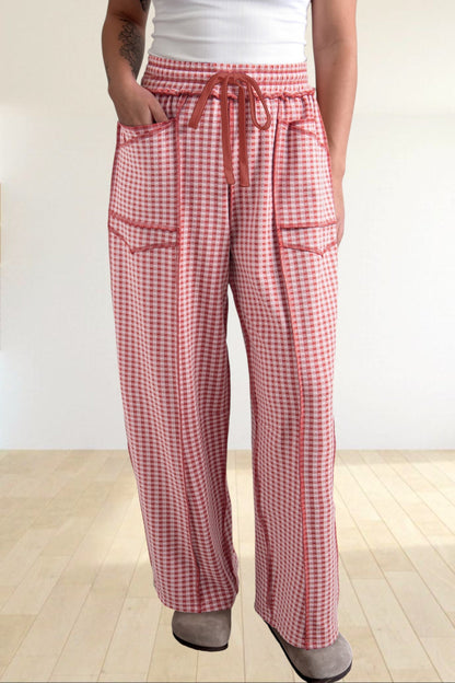 Baya Wear red and white gingham wide leg lounge pants with contrast stitching, drawstring waist, and front pockets.