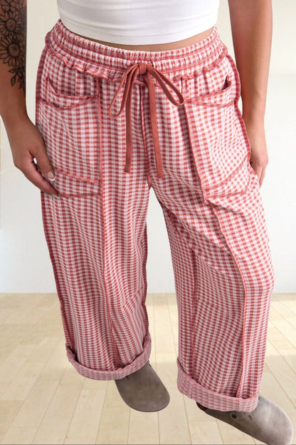Baya Wear wide-leg lounge pants in red and white gingham plaid with contrast stitching, drawstring waist, and pockets.