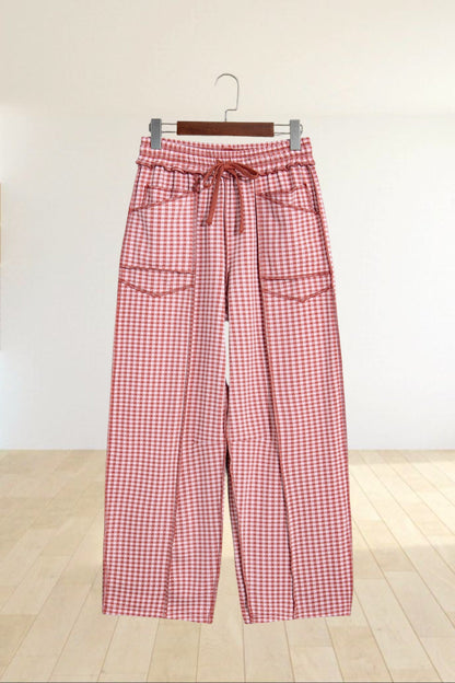 Baya Wear red and white gingham wide leg lounge pants with drawstring waist, front pockets, and contrast stitching.