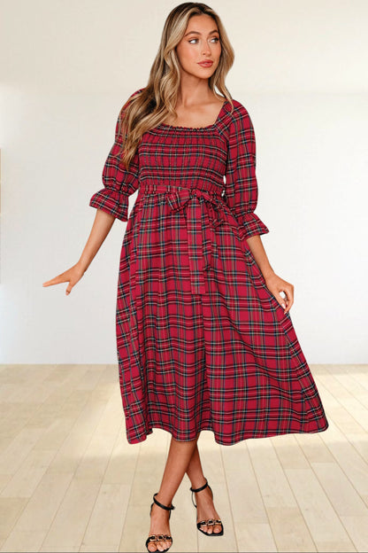Baya Wear red tartan plaid midi dress with a smocked bodice, square neckline, puff sleeves, and a waist tie.