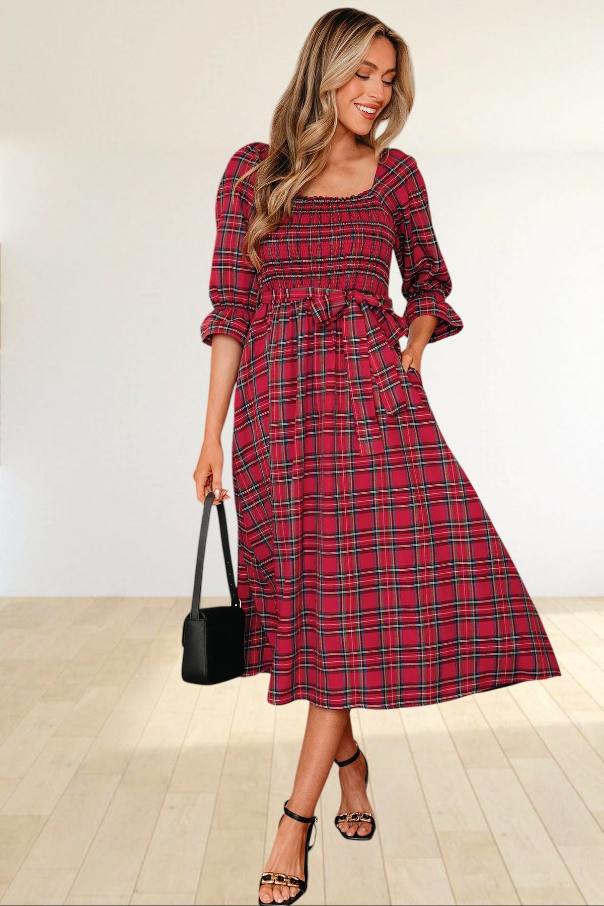 Baya Wear red tartan plaid midi dress with smocked bodice, puff sleeves, and waist tie worn by a smiling woman.