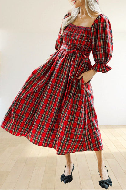 Baya Wear red tartan plaid midi dress with smocked bodice, puff sleeves, and side pockets in a festive setting