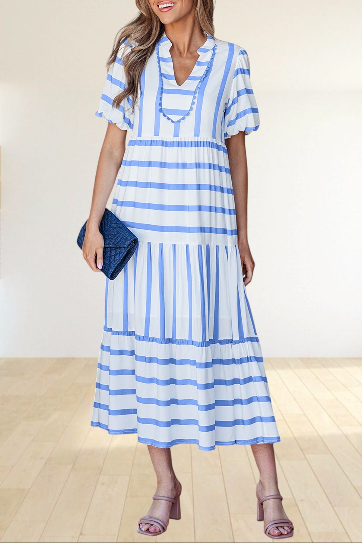 Baya Wear tiered midi dress in white with blue stripes, featuring a notched neckline with ricrac trim and pockets.