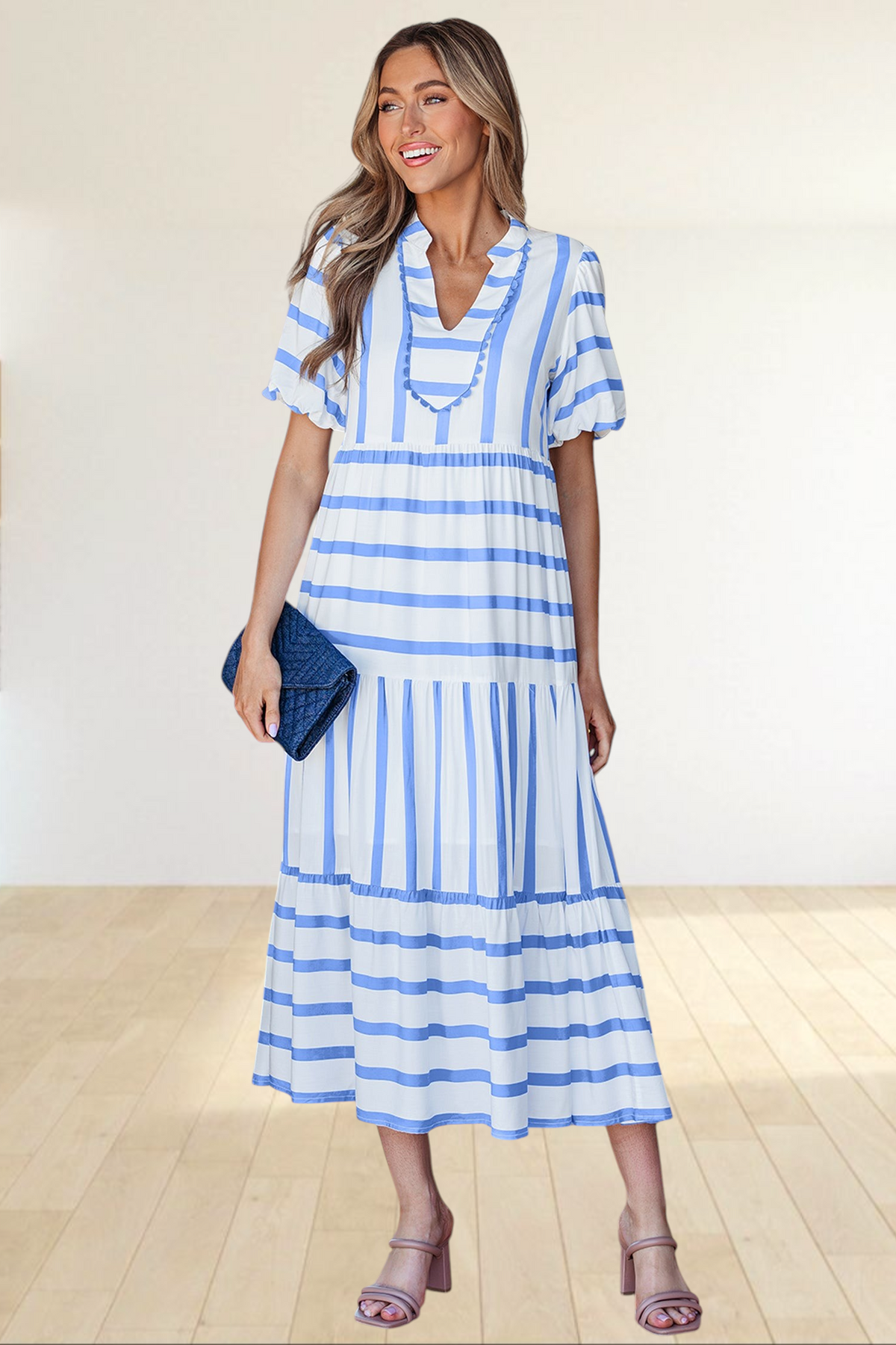 Baya Wear tiered midi dress in white with blue stripes, featuring a notched neckline with ricrac trim and pockets.