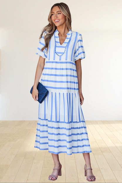 Baya Wear tiered midi dress in white with blue stripes, featuring a notched neckline with ricrac trim and pockets.
