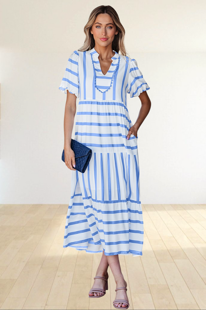 Baya Wear tiered midi dress in white and blue stripes with a notched neckline, ricrac trim, and side pockets.