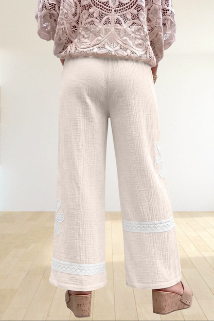 Baya Wear white wide leg trousers with floral lace patchwork and drawstring waist, back view