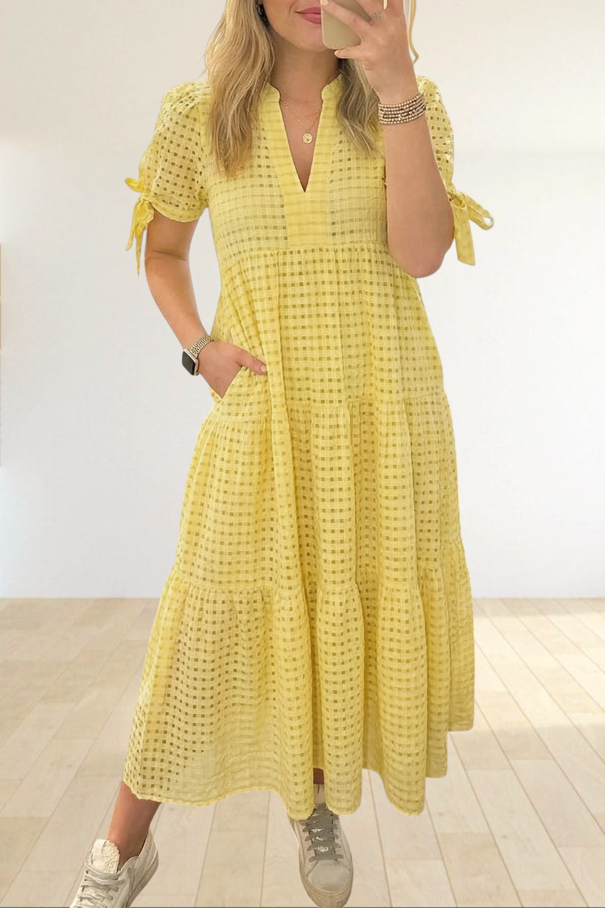 Baya Wear yellow textured gingham tiered midi dress with V-neckline, short sleeves, and side pockets on a woman.