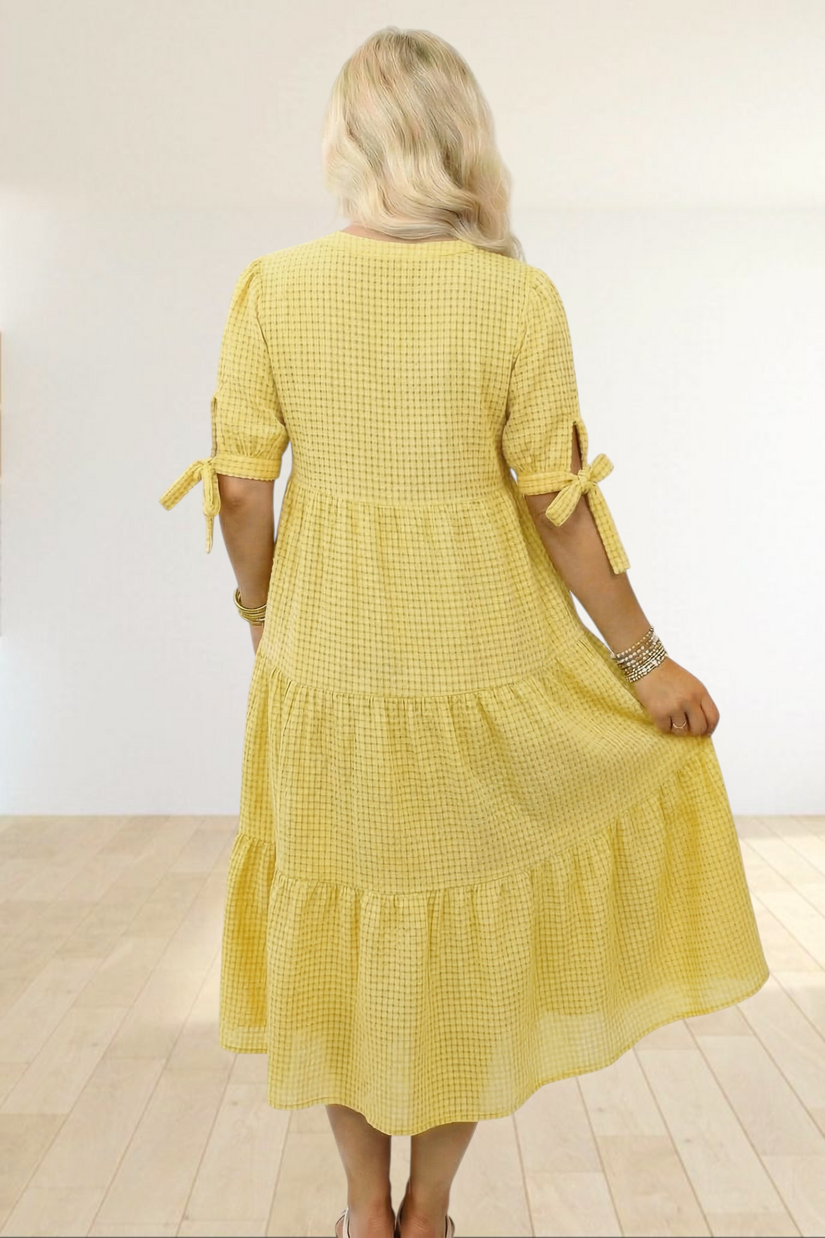 Baya Wear yellow textured gingham midi dress with tiered skirt and short sleeves with bow-tie details, back view