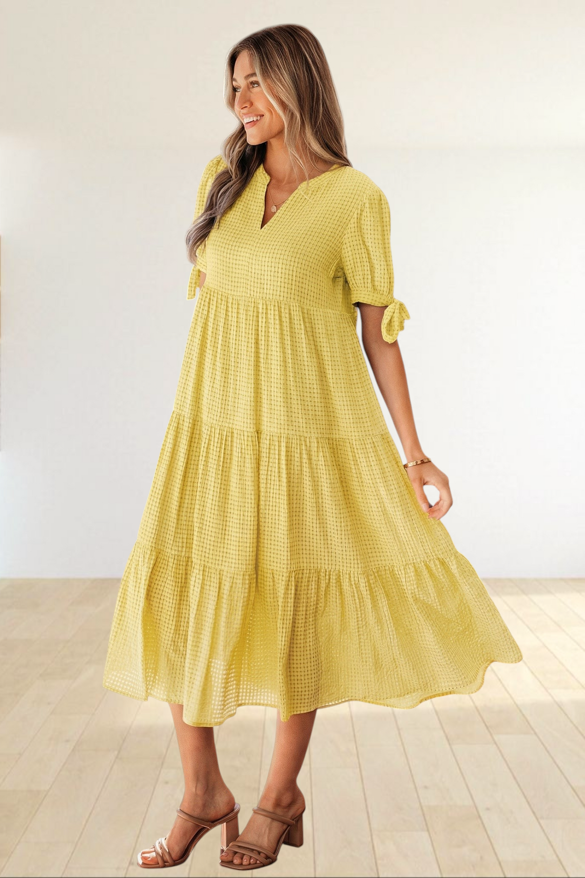 Baya Wear yellow textured gingham midi dress with tiered skirt, V-neckline, and short sleeves with bow-tie details.
